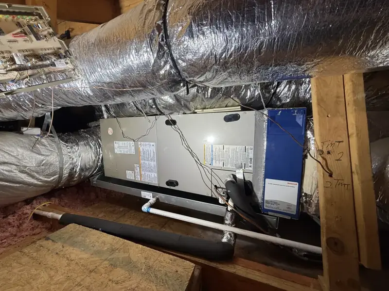 Attic air handler and condensate drain line above a Mooresville ceiling